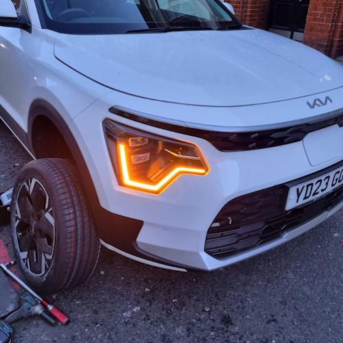Mobile tyre fitting in progress - car with wheel removed